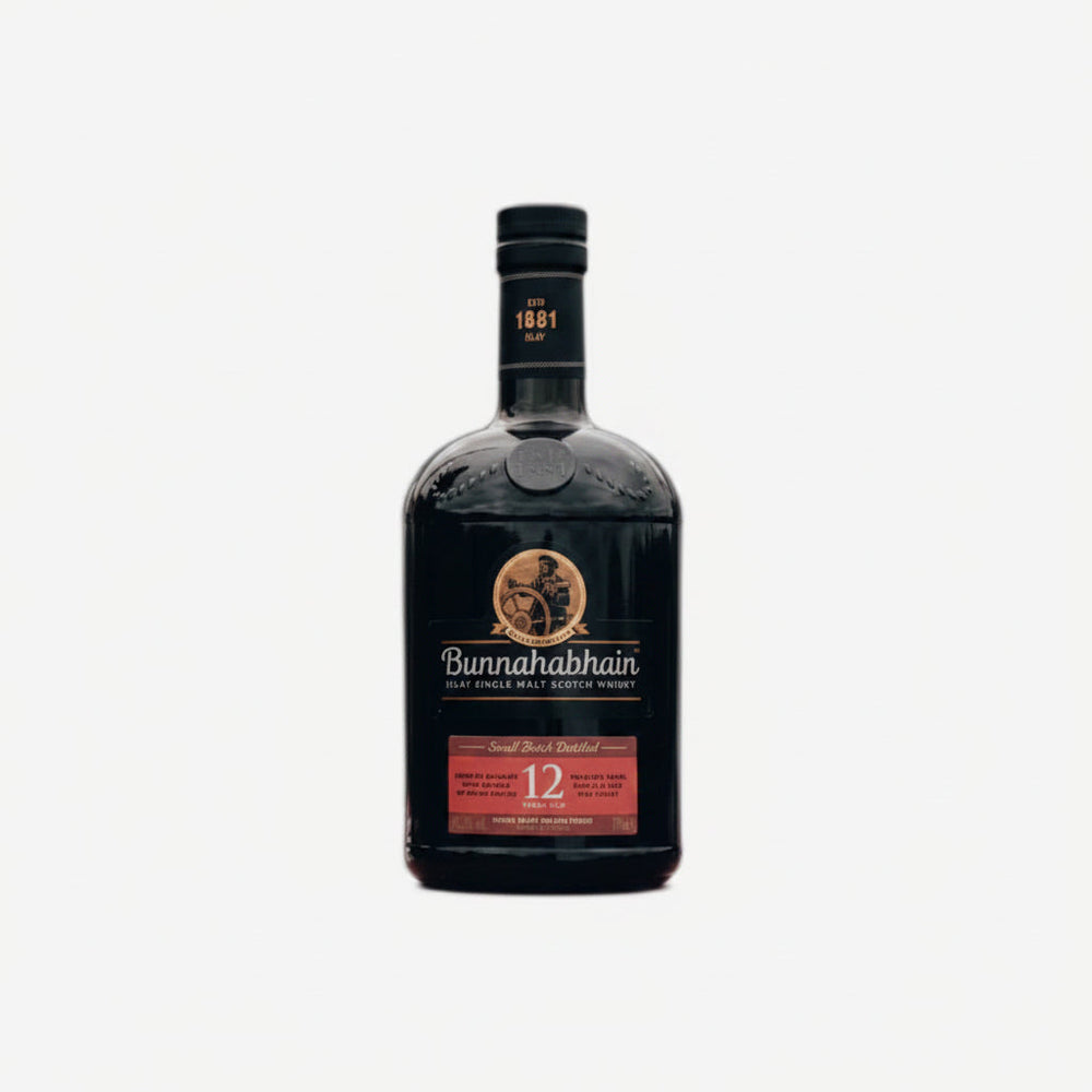 A bottle of Bunnahabhain 12 Year Old Single Malt Whisky stands next to its tall cylindrical packaging box on a clean white background.