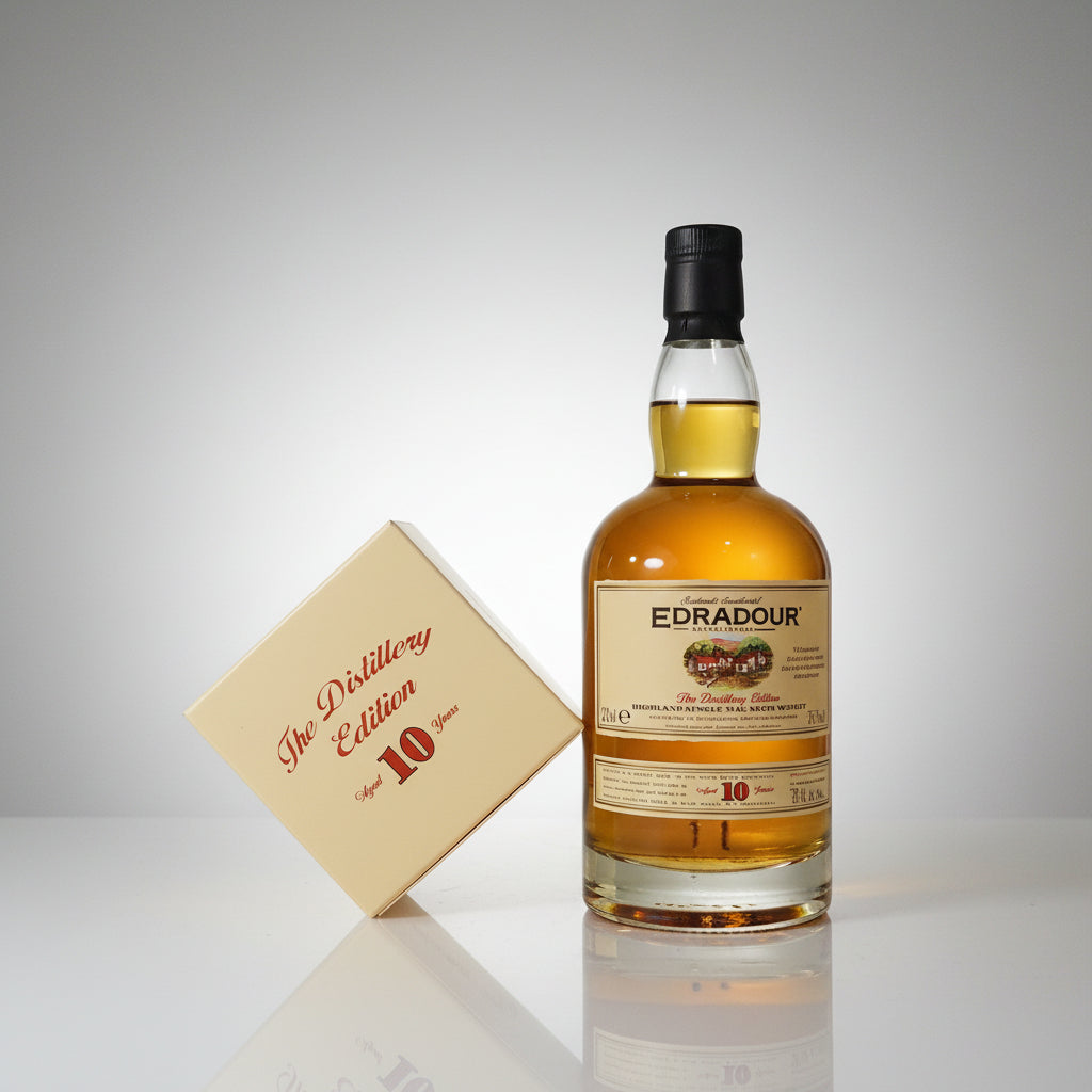 A bottle of Edraillies 10 Year Highland Single Malt Scotch whisky next to its signature cream-colored presentation box, which reads 'The Distillery Edition'.
