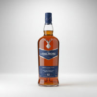 A bottle of The Dalmore 12 Year Old Single Malts Scotch Whisky, showing the amber liquid, a silver stag emblem, and the brand label against a light gray background.