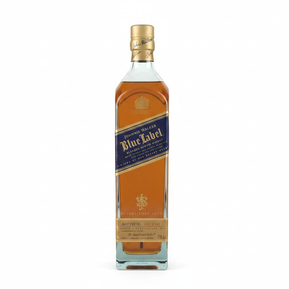 A single bottle of Johnnie Walker Blue Label whisky stands on a plain light gray background. The bottle is made of clear glass and shows the amber-brown liquid inside, with a dark blue label and gold details.