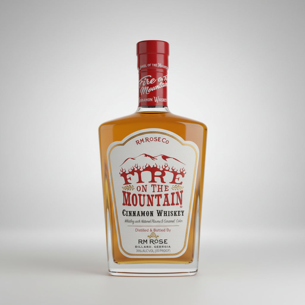 A bottle of Fire on the Mountain Cinnamon Whiskey by RM Rose is shown on a light gray background next to a black text panel with award and flavor descriptions, plus a gold 2021 award badge.