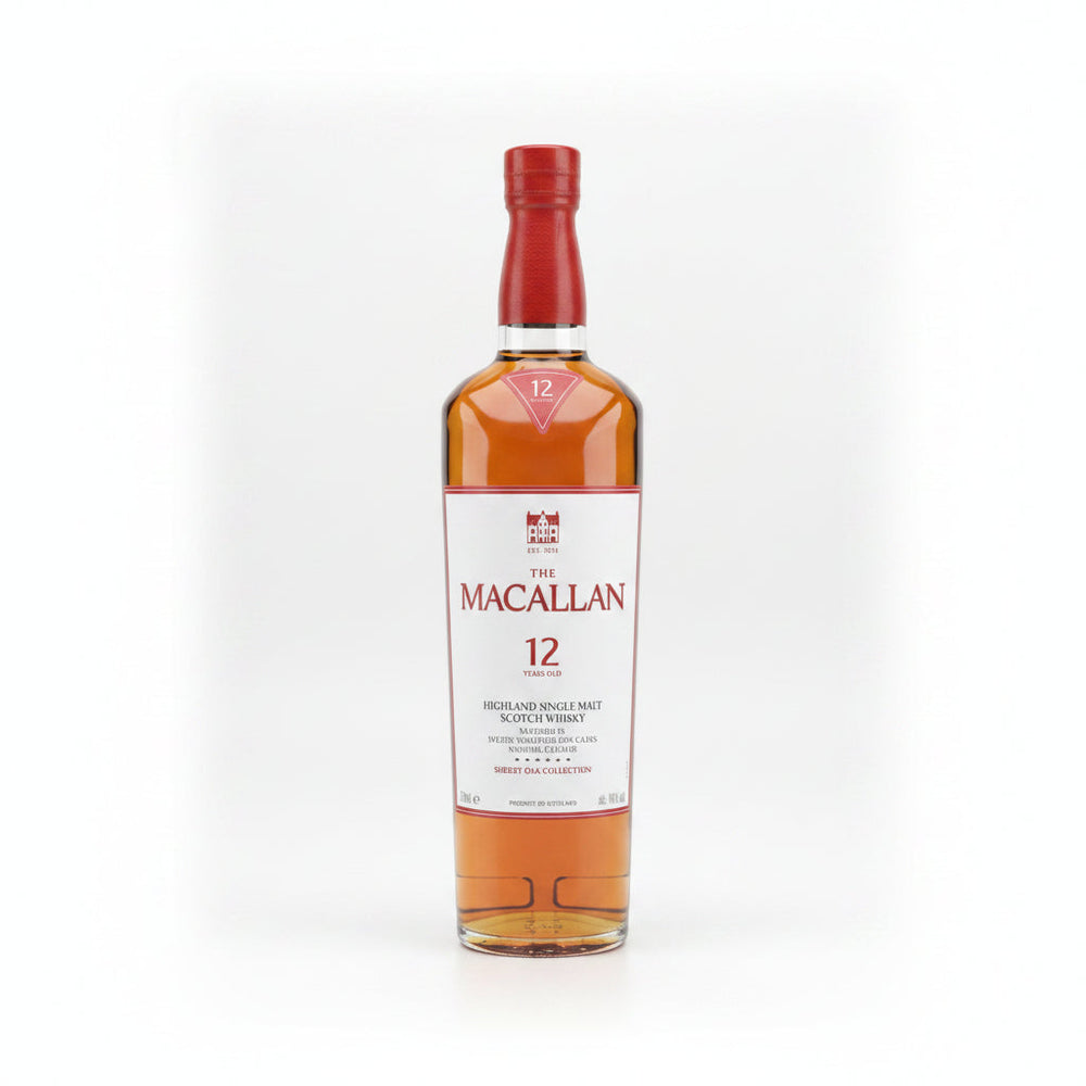 A bottle of The Macallan 12 Years Old single malt Scotch whisky next to its red presentation box and a clear glass, set against a light gray background.